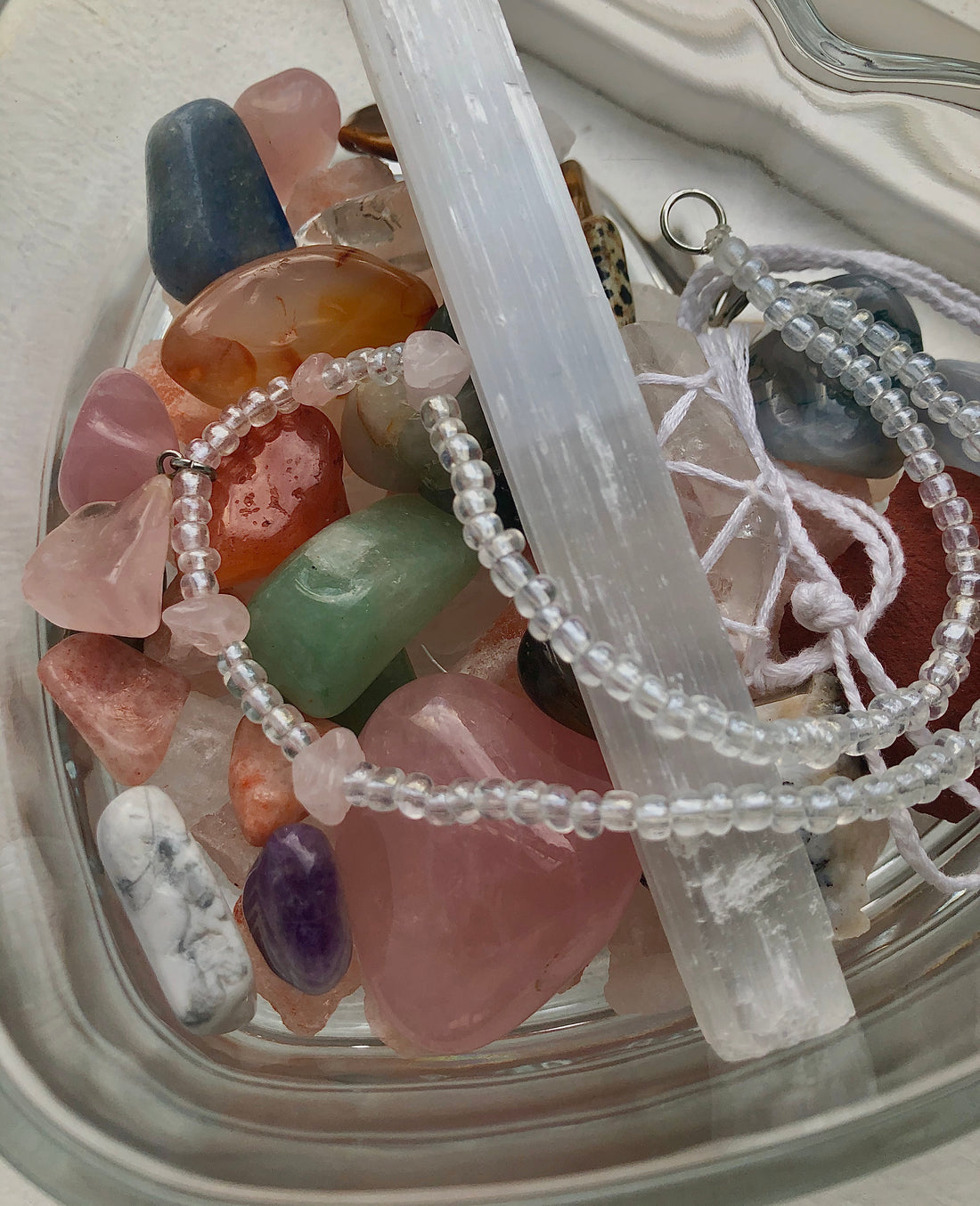 glass bowl filled with various tumbled crystals