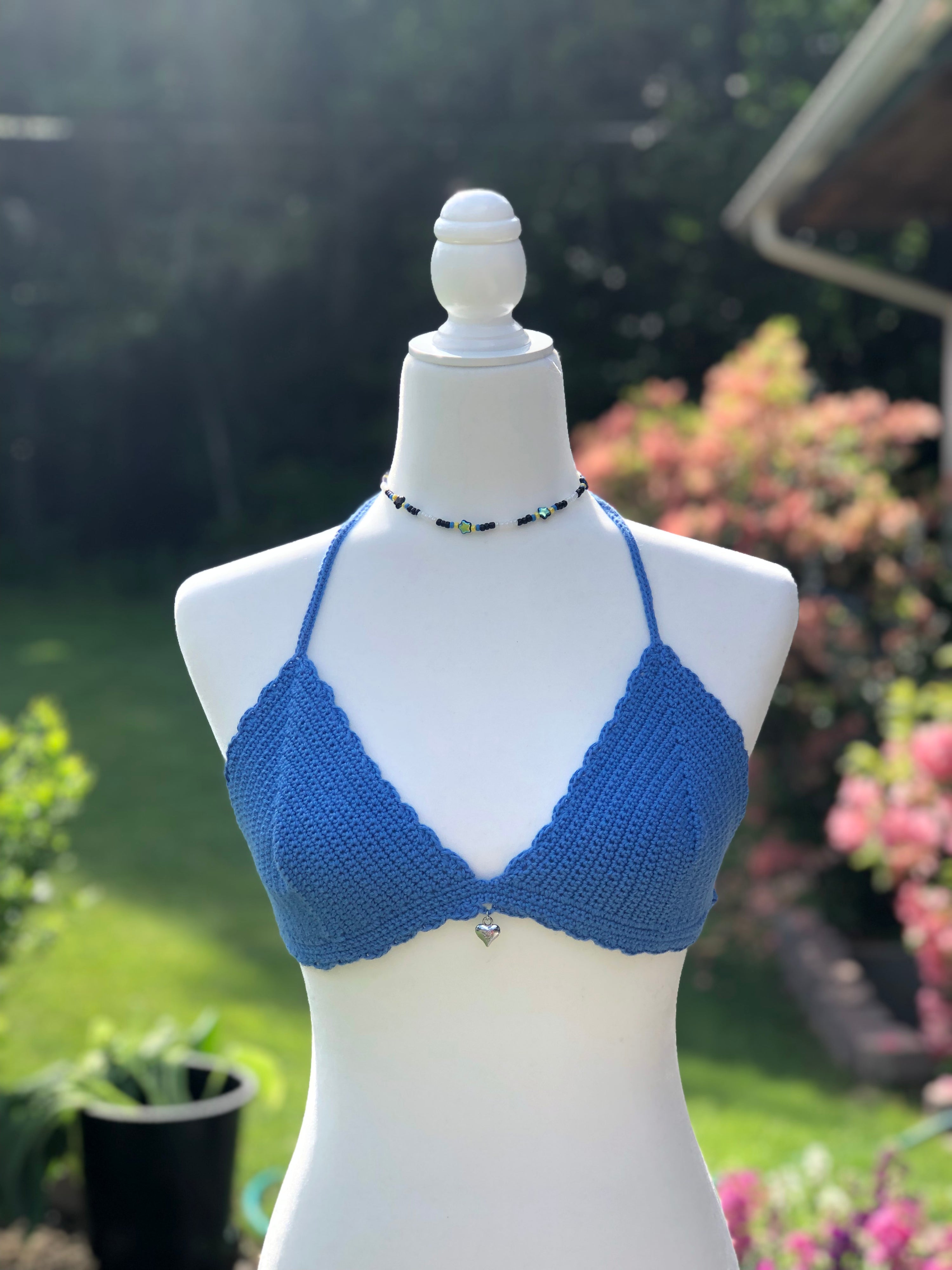 Picture of blue crochet bralette bikini top on white mannequin.